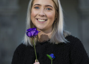 Aoife Rafter poses with a purple rose to mark 65 Roses Day