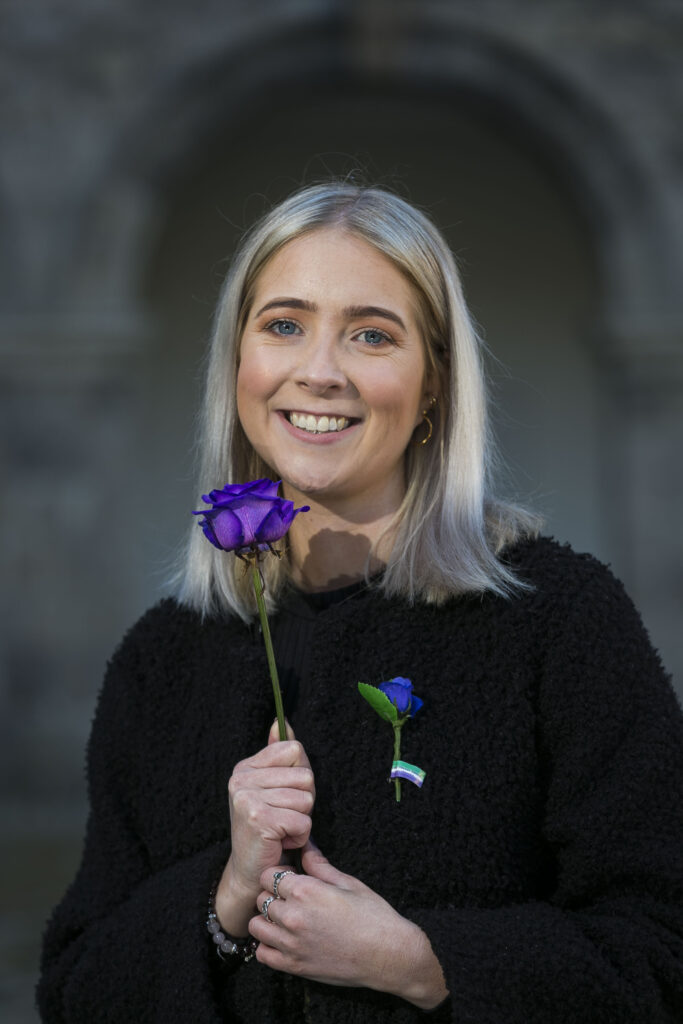 Aoife Rafter poses with a purple rose to mark 65 Roses Day